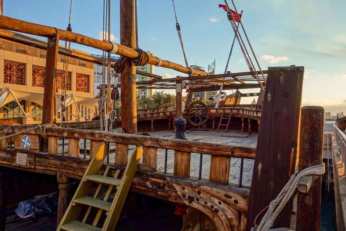 Wooden sailing ship deck with steering wheel