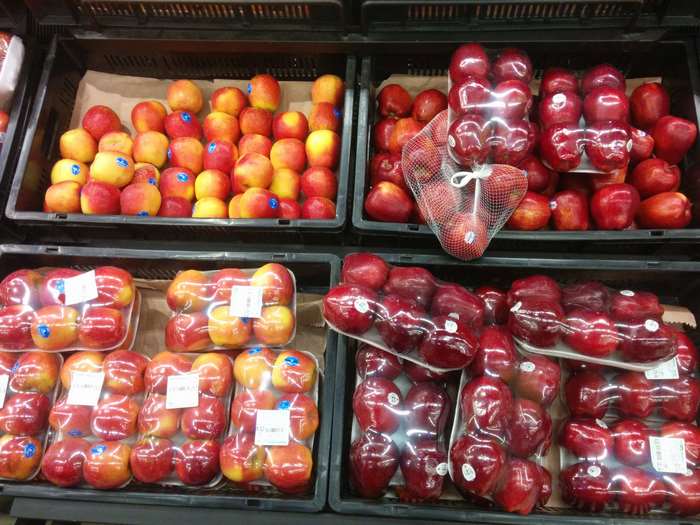 Apples in plastic packaging at a supermarket