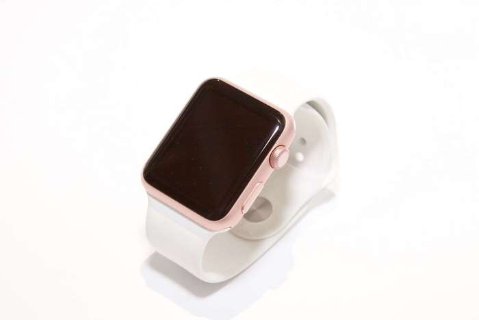 Rose gold Apple Watch with white band