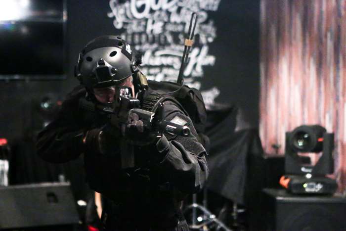 Man in tactical gear holding a rifle