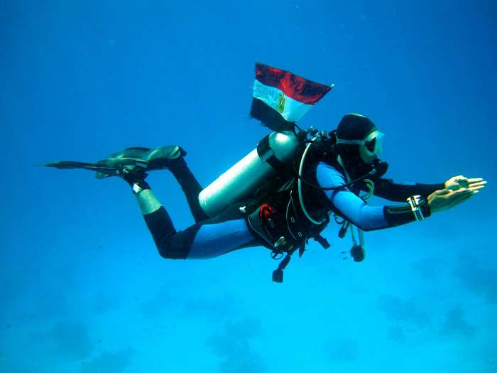 Scuba diver with Egyptian flag underwater