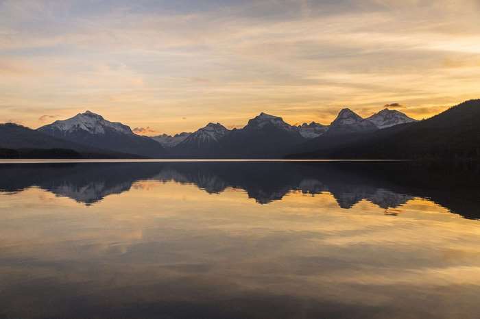 Sunrise over Lake McDonald with snow-capped mountains in Glacier National Park