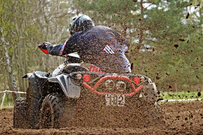 ATV rider racing through mud