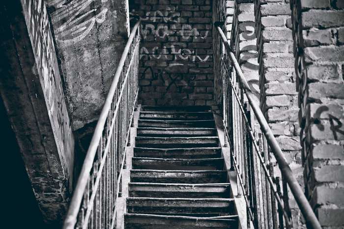 Graffiti-covered staircase in black and white 4K