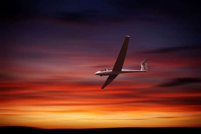 Glider flying at sunset