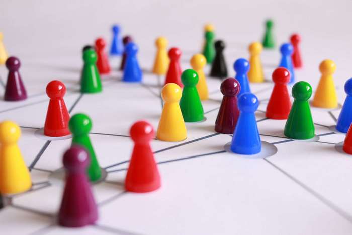 Colorful board game pieces on a network grid