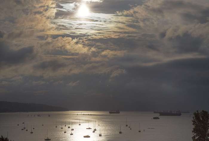 Boats and ships on the water under stormy clouds
