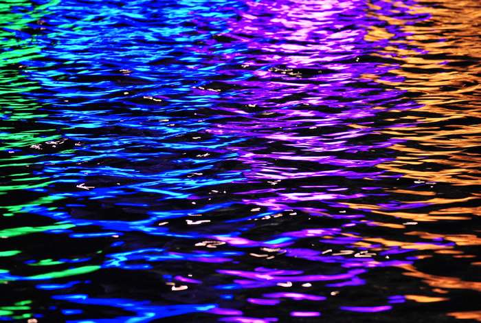 Colorful water reflections on rippling surface