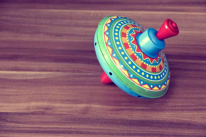 Colorful vintage spinning top on a wooden table