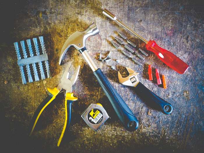 Hammer, pliers, screwdriver, wrench, and wall anchors 4K