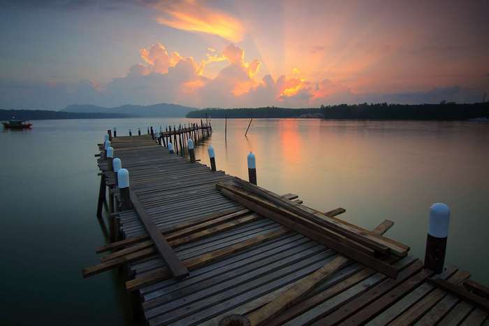 Wooden dock at sunset over a calm lake