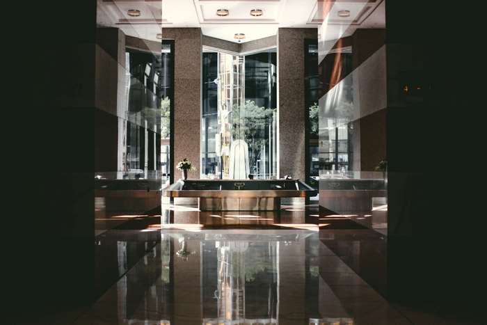 Modern building interior with reception desk and reflections