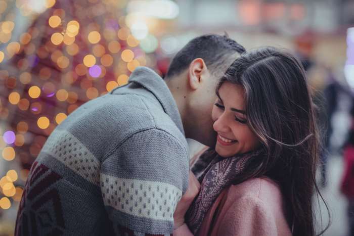 Couple embracing with bokeh lights
