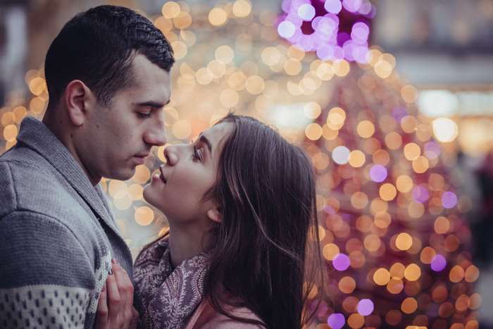 Couple embracing with bokeh lights