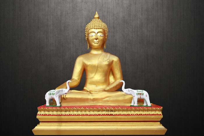 Golden Buddha statue with two white elephants