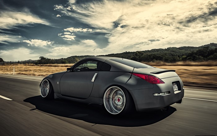 Gray Nissan 350z driving on a road