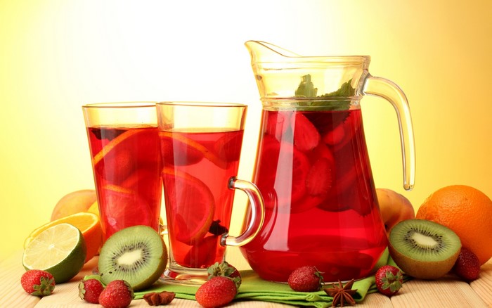 Fruit punch in a pitcher and glasses with fruits
