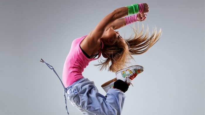 Girl in pink tank top and sweatpants breakdancing