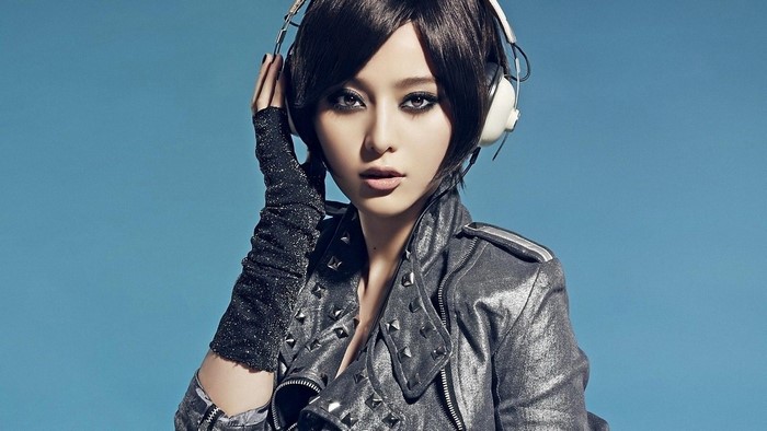 Asian girl with headphones and studded jacket