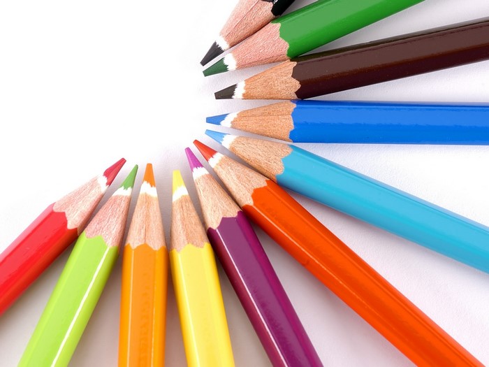 Colored pencils arranged in a semi-circle on a white background