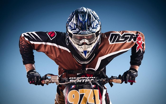 Motocross rider in full gear on a dirt bike