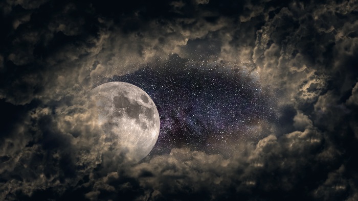 Moon and stars through clouds