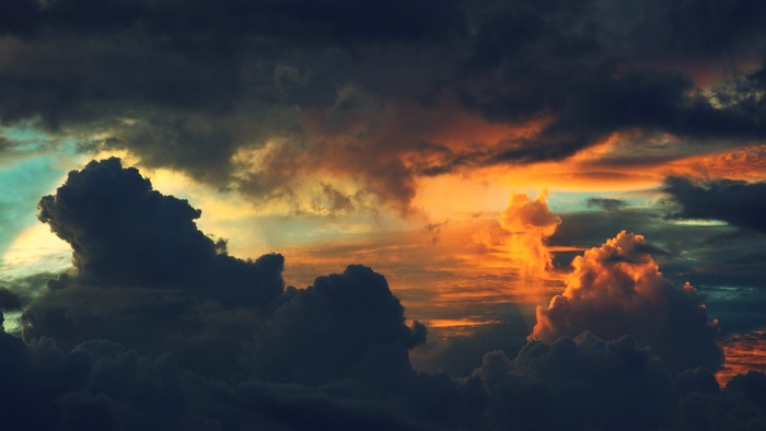 Dramatic sunset sky with dark and orange clouds