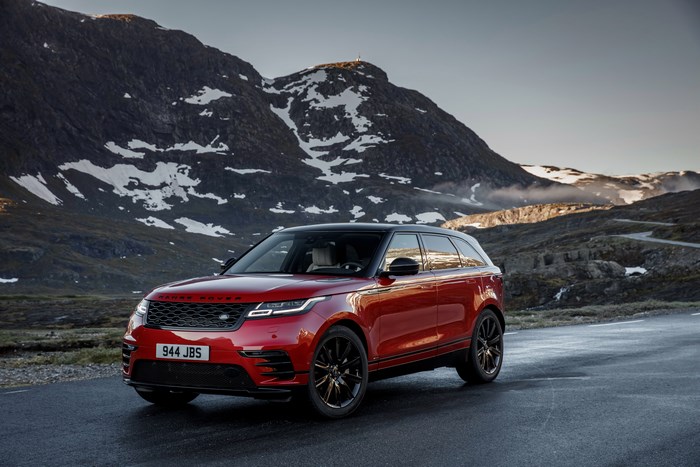 Red Range Rover Velar on a mountain road