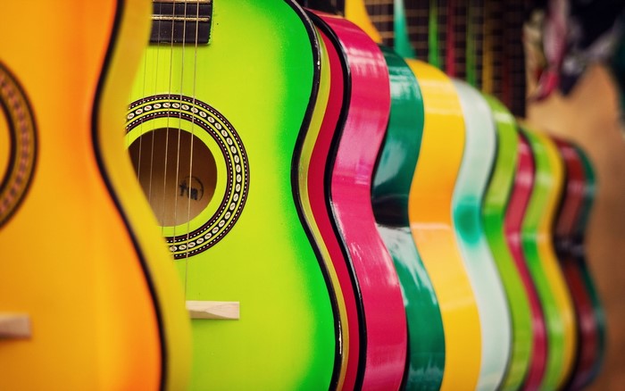 Row of colorful acoustic guitars