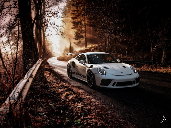 White Porsche 911 GT3 RS on a forest road