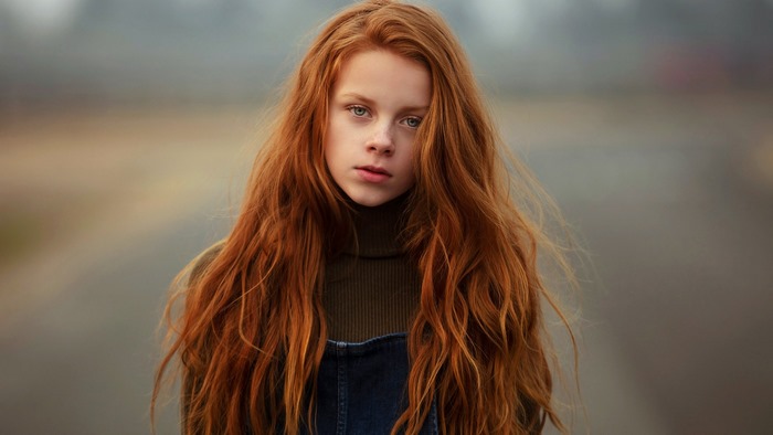 Young redhead girl with long wavy hair