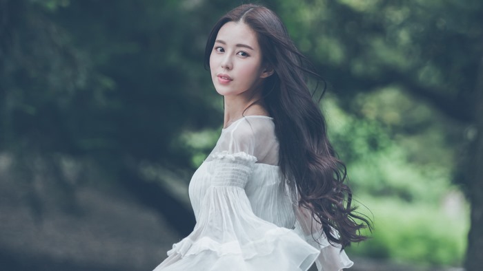 Portrait of a Woman with Long Black Hair in Nature