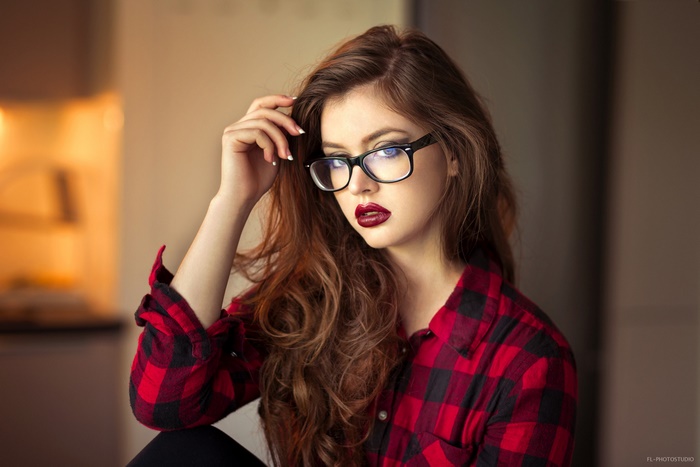 Woman with glasses and red plaid shirt