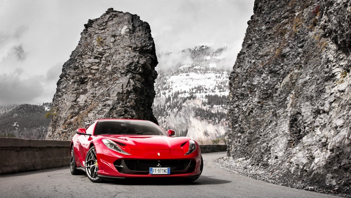 Red Ferrari 812 Superfast on a mountain road