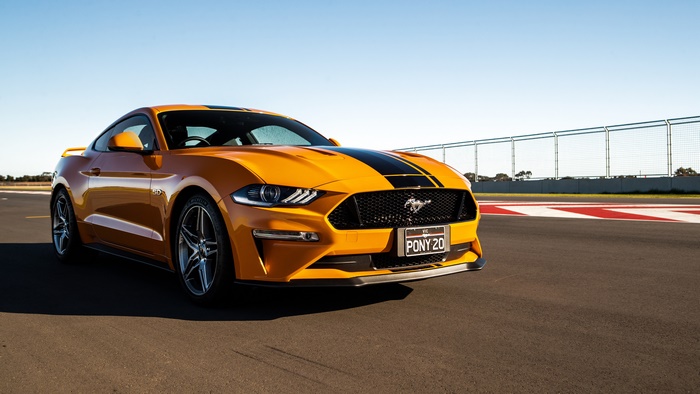 Orange Ford Mustang GT on a Racetrack