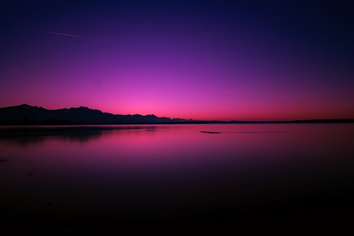 4K Sunset over a Lake with Mountains