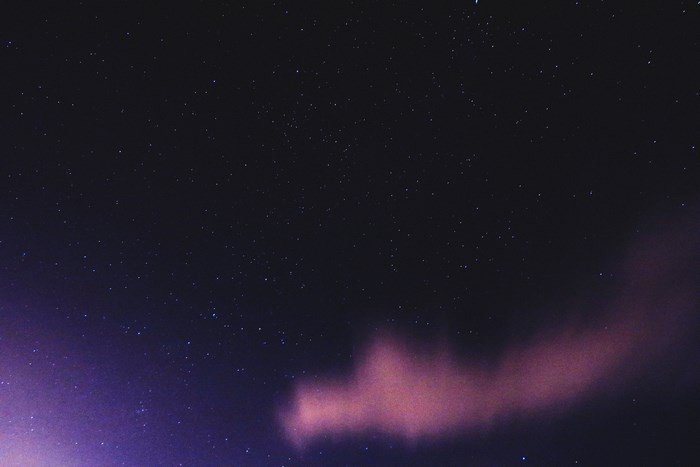 Night sky with stars and purple clouds