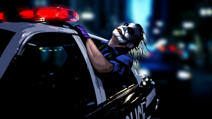 The Joker leaning out of a police car