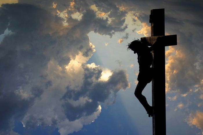 Jesus on the cross against a cloudy sky