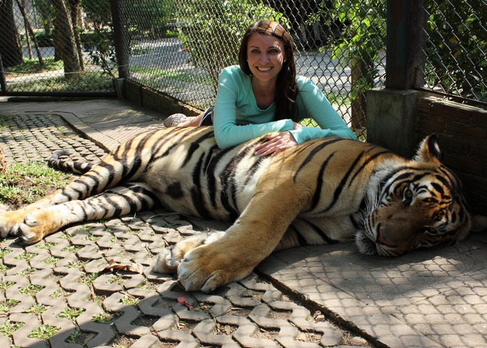 Woman resting on a tiger