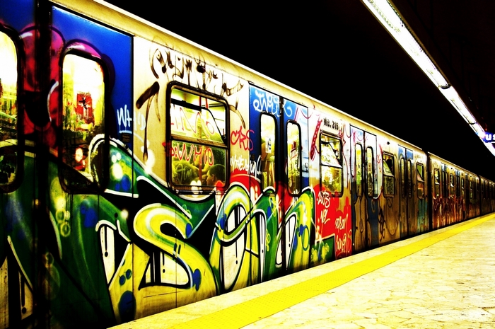 Graffiti-covered subway train at a station