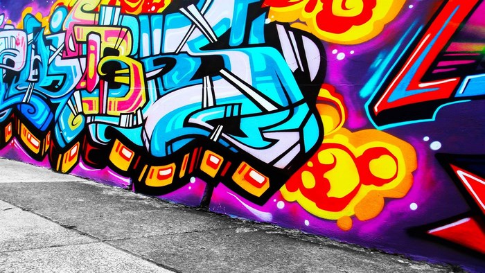 Colorful graffiti art on a purple wall