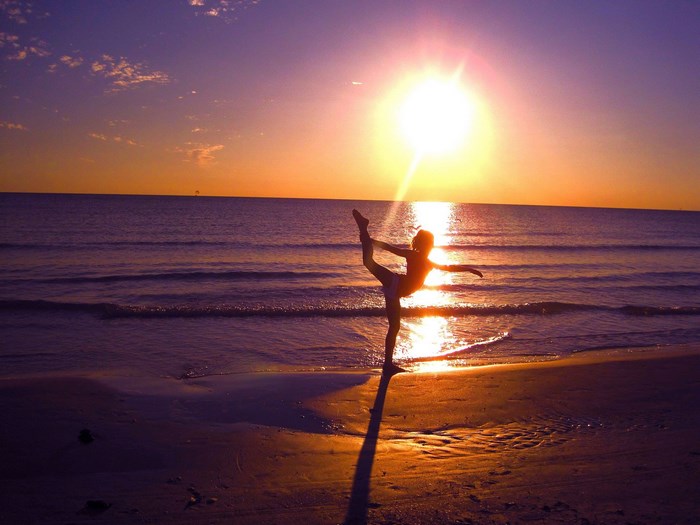 Silhouette of a dancer at sunset on the beach