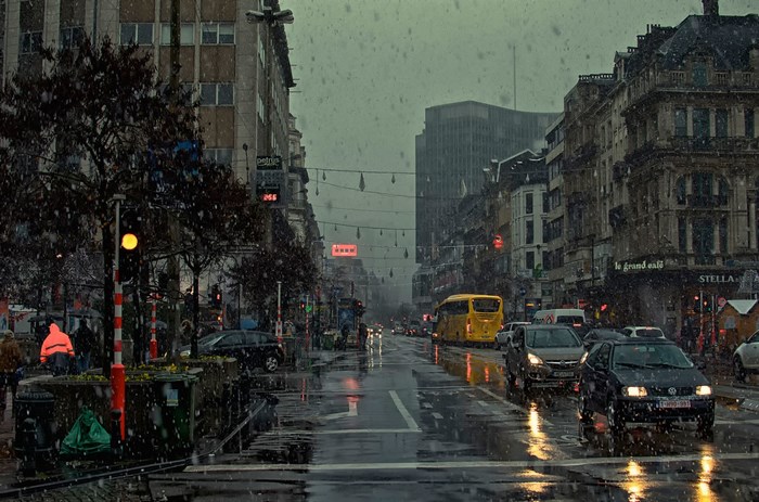 City street in the rain with cars and buildings
