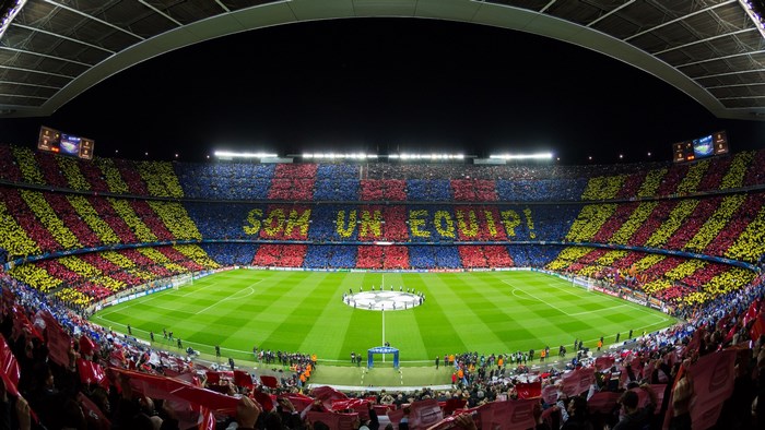 Camp Nou stadium with fans displaying 'Som Un Equip' mosaic
