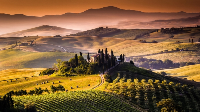 Tuscan landscape with cypress trees and rolling hills