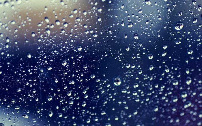 Raindrops on a dark blue surface