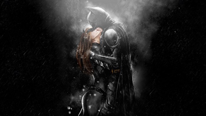 Batman and Catwoman kissing in the rain