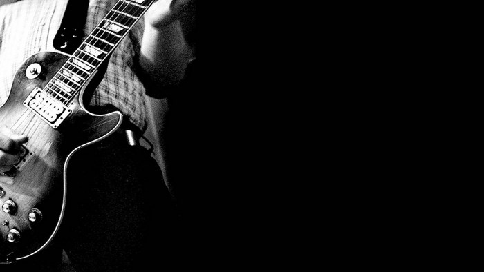 Close-up of a person playing a guitar