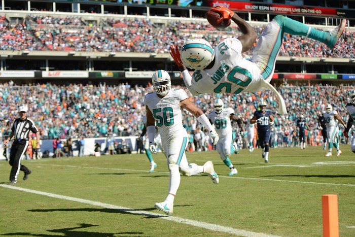 Miami Dolphins Player Catching Football Mid-Air